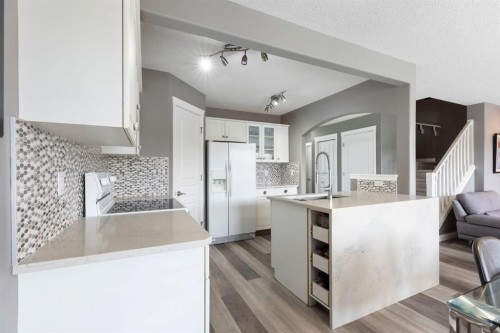 18 West Springs Gate Sw, Calgary, AB - Indoor Photo Showing Kitchen With Upgraded Kitchen