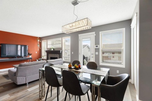 18 West Springs Gate Sw, Calgary, AB - Indoor Photo Showing Dining Room With Fireplace