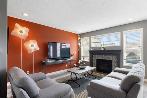 18 West Springs Gate Sw, Calgary, AB - Indoor Photo Showing Living Room With Fireplace