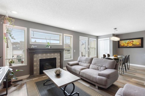18 West Springs Gate Sw, Calgary, AB - Indoor Photo Showing Living Room With Fireplace