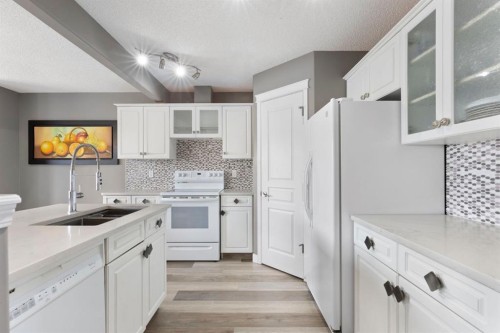 18 West Springs Gate Sw, Calgary, AB - Indoor Photo Showing Kitchen With Double Sink
