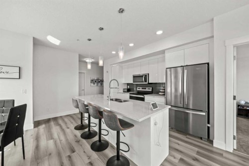 305-19661 40 Street Se, Calgary, AB - Indoor Photo Showing Kitchen With Stainless Steel Kitchen With Double Sink With Upgraded Kitchen