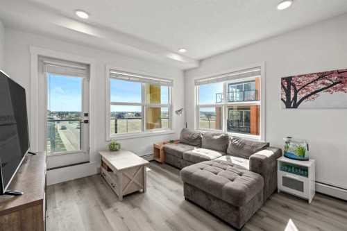 305-19661 40 Street Se, Calgary, AB - Indoor Photo Showing Living Room