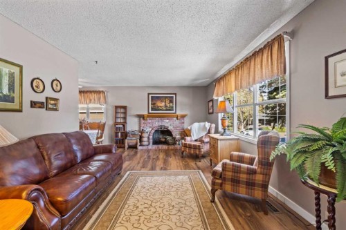 7 Canna Bay Sw, Calgary, AB - Indoor Photo Showing Living Room With Fireplace