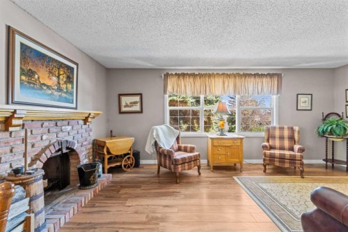 7 Canna Bay Sw, Calgary, AB - Indoor Photo Showing Living Room With Fireplace