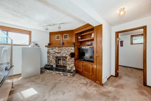 131 Ranchlands Court Nw, Calgary, AB - Indoor Photo Showing Other Room With Fireplace