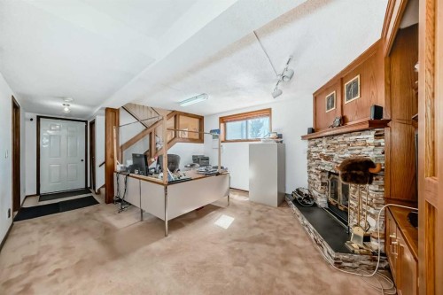 131 Ranchlands Court Nw, Calgary, AB - Indoor Photo Showing Other Room With Fireplace