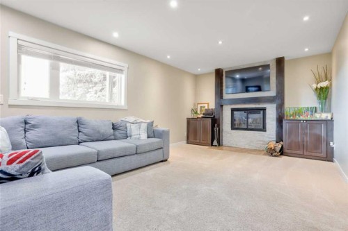 228 Wood Valley Bay Sw, Calgary, AB - Indoor Photo Showing Living Room With Fireplace