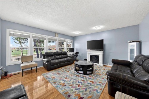 3620 28 Street Se, Calgary, AB - Indoor Photo Showing Living Room With Fireplace