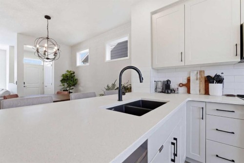 48 Magnolia Parade Se, Calgary, AB - Indoor Photo Showing Kitchen With Double Sink