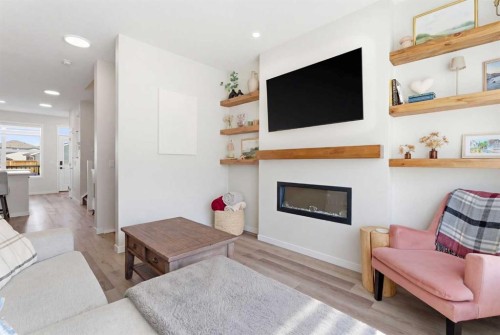 48 Magnolia Parade Se, Calgary, AB - Indoor Photo Showing Living Room With Fireplace