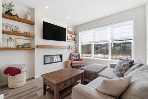 48 Magnolia Parade Se, Calgary, AB - Indoor Photo Showing Living Room With Fireplace