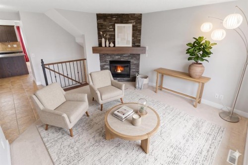 25 Everridge Way Sw, Calgary, AB - Indoor Photo Showing Living Room With Fireplace