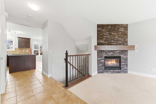 25 Everridge Way Sw, Calgary, AB - Indoor Photo Showing Living Room With Fireplace