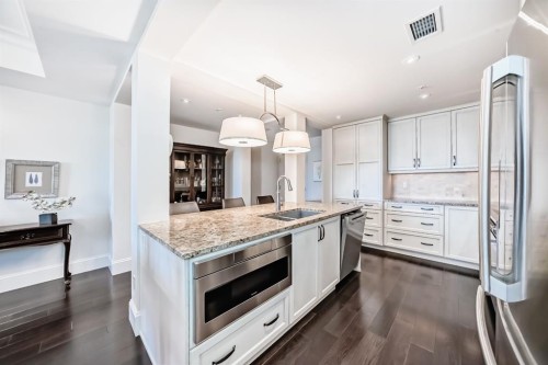 404-211 Quarry Way Se, Calgary, AB - Indoor Photo Showing Kitchen With Double Sink With Upgraded Kitchen