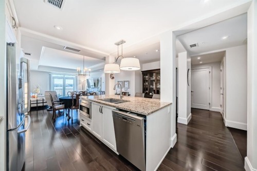 404-211 Quarry Way Se, Calgary, AB - Indoor Photo Showing Kitchen With Stainless Steel Kitchen With Double Sink With Upgraded Kitchen