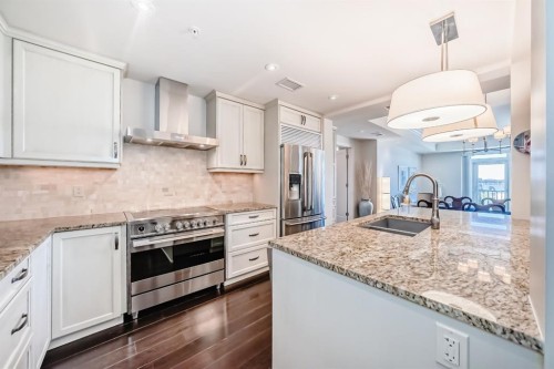 404-211 Quarry Way Se, Calgary, AB - Indoor Photo Showing Kitchen With Double Sink With Upgraded Kitchen