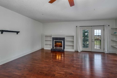 213-77 George Fox Trail West, Cochrane, AB - Indoor Photo Showing Living Room With Fireplace