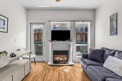 211-176 Kananaskis Way, Canmore, AB - Indoor Photo Showing Living Room With Fireplace