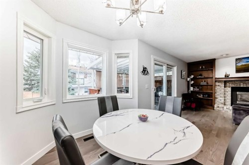7 Sunset Crescent, Okotoks, AB - Indoor Photo Showing Dining Room With Fireplace
