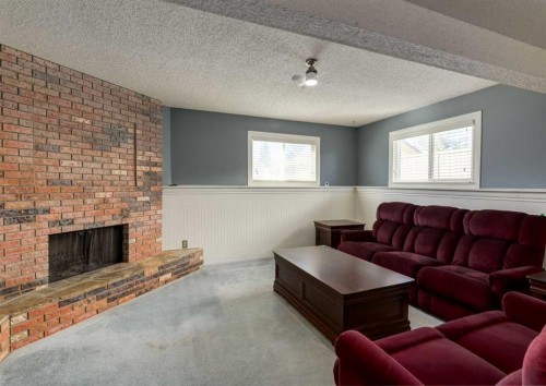 223 Cedarwood Road Sw, Calgary, AB - Indoor Photo Showing Living Room With Fireplace