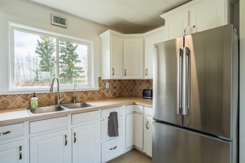 370 16 Avenue, Diamond Valley, AB - Indoor Photo Showing Kitchen With Double Sink
