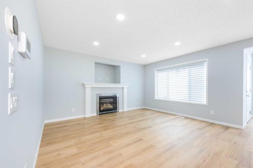 8454 Saddleridge Drive Ne, Calgary, AB - Indoor Photo Showing Living Room With Fireplace