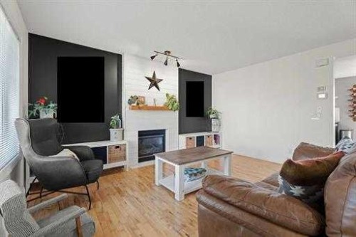 529 Railway Avenue, Langdon, AB - Indoor Photo Showing Living Room With Fireplace