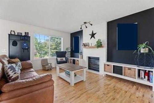 529 Railway Avenue, Langdon, AB - Indoor Photo Showing Living Room With Fireplace
