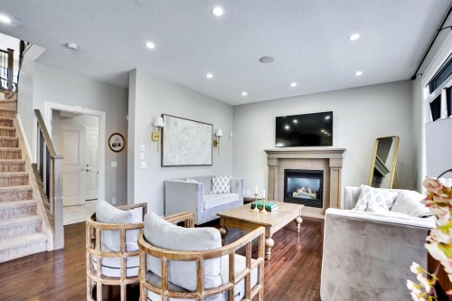 117 Hawkmere Place, Chestermere, AB - Indoor Photo Showing Living Room With Fireplace