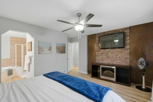 129 Cranfield Green Se, Calgary, AB - Indoor Photo Showing Bedroom With Fireplace