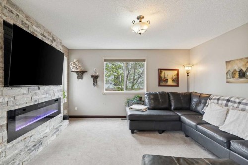 48 Westridge Drive, Okotoks, AB - Indoor Photo Showing Living Room With Fireplace