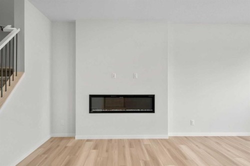 675 Buffaloberry Manor Se, Calgary, AB - Indoor Photo Showing Living Room With Fireplace