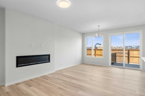 675 Buffaloberry Manor Se, Calgary, AB - Indoor Photo Showing Living Room With Fireplace