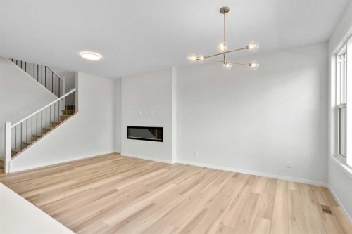 675 Buffaloberry Manor Se, Calgary, AB - Indoor Photo Showing Other Room With Fireplace