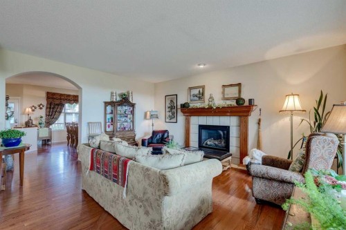 40 Springbank Bay Sw, Calgary, AB - Indoor Photo Showing Living Room With Fireplace