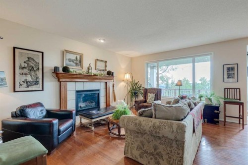 40 Springbank Bay Sw, Calgary, AB - Indoor Photo Showing Living Room With Fireplace