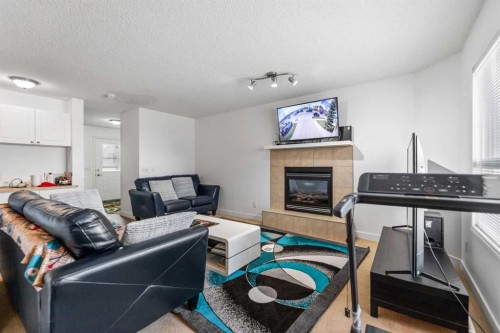100 Saddlecrest Boulevard Ne, Calgary, AB - Indoor Photo Showing Living Room With Fireplace