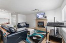 100 Saddlecrest Boulevard Ne, Calgary, AB  - Indoor Photo Showing Living Room With Fireplace 