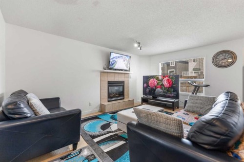100 Saddlecrest Boulevard Ne, Calgary, AB - Indoor Photo Showing Living Room With Fireplace