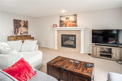 4 Springbank Bay Sw, Calgary, AB - Indoor Photo Showing Living Room With Fireplace