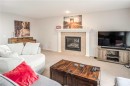 4 Springbank Bay Sw, Calgary, AB  - Indoor Photo Showing Living Room With Fireplace 