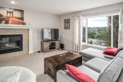 4 Springbank Bay Sw, Calgary, AB - Indoor Photo Showing Living Room With Fireplace