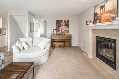 4 Springbank Bay Sw, Calgary, AB - Indoor Photo Showing Living Room With Fireplace
