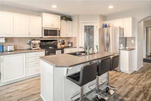 4 Springbank Bay Sw, Calgary, AB - Indoor Photo Showing Kitchen With Stainless Steel Kitchen With Double Sink