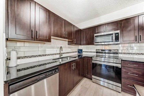 1312-755 Copperpond Boulevard Se, Calgary, AB - Indoor Photo Showing Kitchen With Double Sink With Upgraded Kitchen