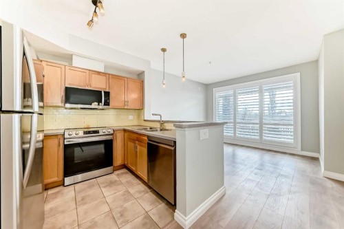 2-132 Rockyledge View Nw, Calgary, AB - Indoor Photo Showing Kitchen With Double Sink