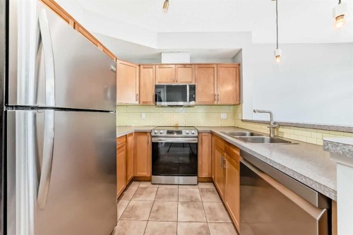 2-132 Rockyledge View Nw, Calgary, AB - Indoor Photo Showing Kitchen With Double Sink