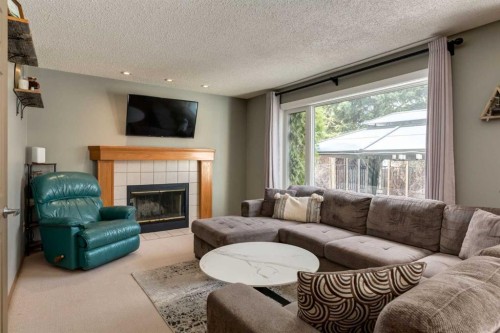 159 Macewan Drive Nw, Calgary, AB - Indoor Photo Showing Living Room With Fireplace