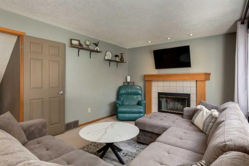 159 Macewan Drive Nw, Calgary, AB - Indoor Photo Showing Living Room With Fireplace